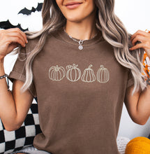 Pumpkins embroidered on a comfort colors tshirt. 